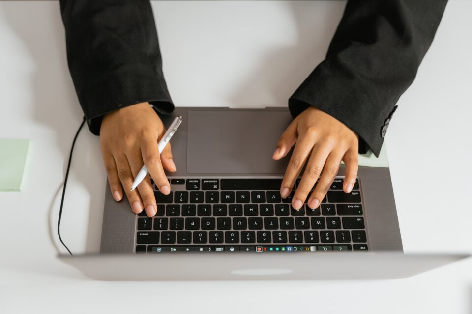 woman typing on laptop