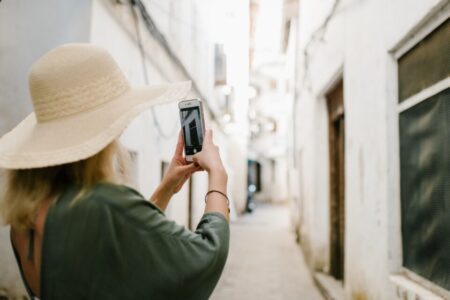 WOMAN POSING WITH MOBILE PHONE ABROAD
